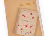 a book with a red heart on it sitting on a piece of paper