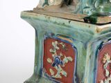 a figurine of a man and a dog sitting on a box