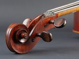 a close up of a violin ' s bow and strings on a gray background