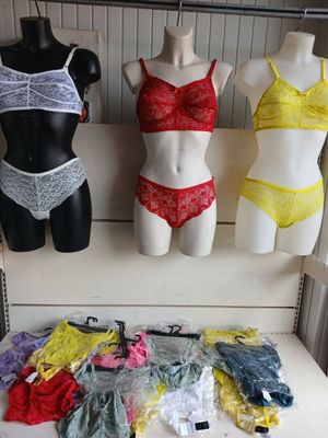 several mannequins and lingersuits are on display in a store