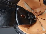 a close up of a leather hat with a leather belt