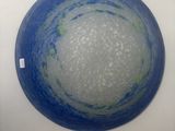 a blue and white bowl sitting on a white wall