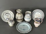 many different types of pottery on display on the table