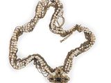 pearl and gold necklace on a white background with a flower