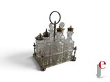 a silver and glass table with a candle holder on it