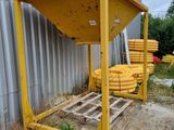 a pile of yellow hoses sitting on a pallet next to a building