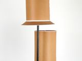 a lamp that is on a stand with a lamp shade on top of it