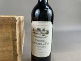 a bottle of wine sitting next to a wooden box