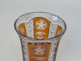 a glass vase with a floral design on it