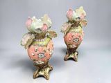 pair of pink and green vases with flowers on them