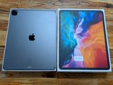 an apple ipad pro with its box open on a wooden table