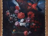 painting of flowers and birds in a gold frame on a black background