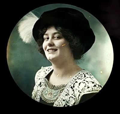 a black and white photo of a woman with a feather in her hair