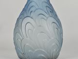 a glass vase with a blue and white design on it