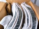 a cardboard box filled with a bunch of white plates