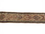 an old rug with a long design on a white background