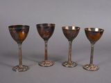 three silver goblets sitting next to each other on a table