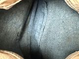 the inside of a blue purse with a zipper on the inside of it