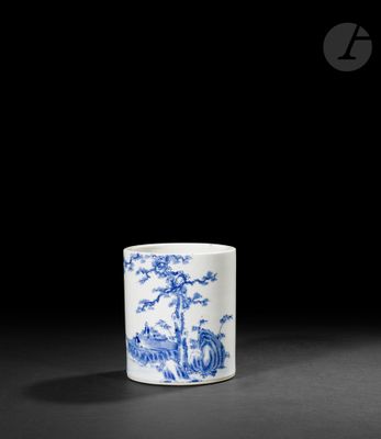une tasse bleue et blanche ornée d'un motif représentant un paysage
