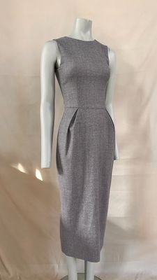 a mannequin dress on a mannequin stand against a white backdrop
