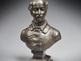 un buste en bronze représentant un homme en costume-cravate