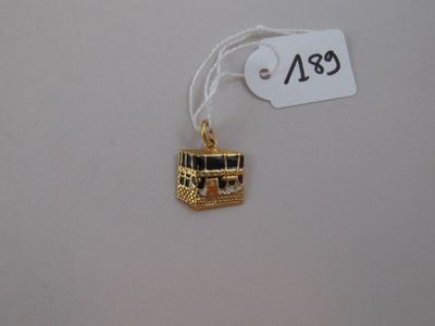 a gold charm that is hanging from a string