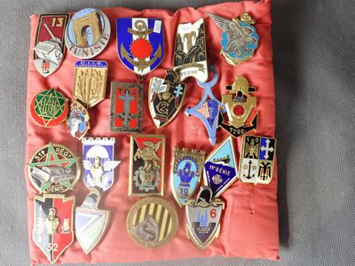a red pillow with a bunch of badges on it