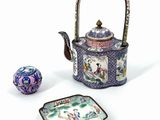 a tea pot and a plate with a bird on it