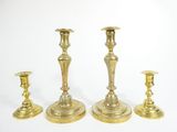 three brass candlesticks on a white background with a white background
