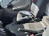 a seat in the back of a truck with a steering wheel