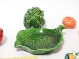 a green leaf shaped dish with a green leaf on top of it