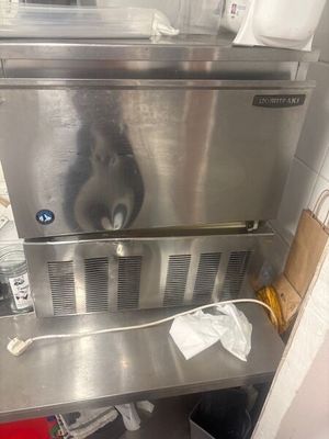 a cat that is sitting on top of a stainless steel oven
