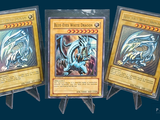 three cards are on display on a stand with a blue background
