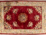 an image of a red rug with a floral design on it