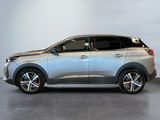 a silver suv parked in a garage with a white wall behind it
