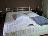 a bed that has a mattress on it in a room
