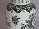 a white vase with a black and white design on it