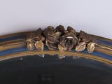 a mirror with a flower decoration on the top of it