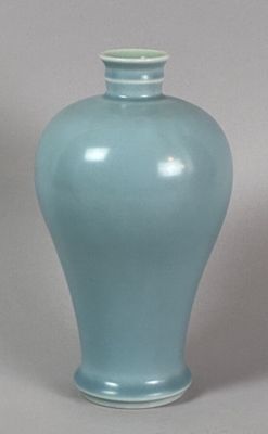 a blue vase that is sitting on a table