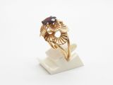 a close up of a gold ring with a black stone on it