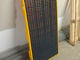 a radiator in the corner of a room next to a pallet