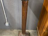 a wooden pedestal with a wooden top and a wooden base