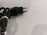 a black cord that is plugged into a white surface