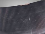a close up of a metal object on a black surface