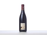 the bottle of red wine is sitting on the table