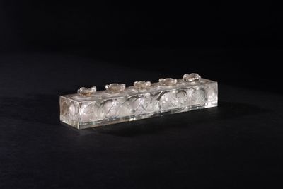 clear crystal candle holder on a black surface with a black background