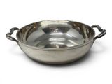 a large metal bowl with handles on a white surface