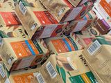 many bags of coffee sitting on top of each other