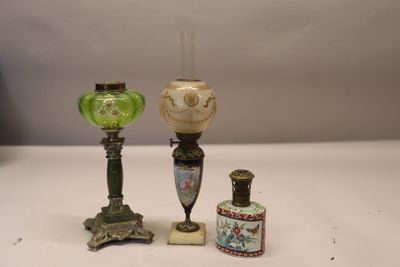 three different vases and a lamp on a table