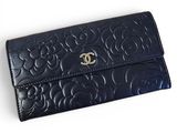 a close up of a black purse on a white surface